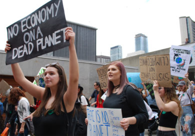 Sign held high: No Economy on a Dead Planet.